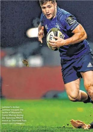  ?? RAMSEY CARDY/SPORTSFILE ?? Leinster’s Jordan Larmour escapes the tackle of Munster’s Conor Murray during the Guinness PRO14 match at Thomond Park