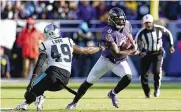  ?? PATRICK SEMANSKY / AP ?? Ravens quarterbac­k Lamar Jackson gets by Carolina Panthers linebacker Frankie Luvu in the first half Sunday in Baltimore. Jackson scored the game’s only touchdown in a 13-3 win.