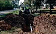  ??  ?? County worker uncovers a ruptured water line near Ridgeland High School last September. (Messenger photo/Josh O’Bryant)