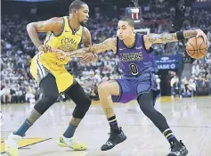  ??  ?? Kyle Kuzma (right) of the Los Angeles Lakers dribbles the ball while being closely guarded by Kevin Durant of the Golden State Warriors during the first half of their NBA Basketball game at ORACLE Arena in Oakland, California. — AFP photo