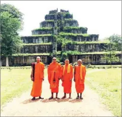  ?? SUPPLIED ?? Monks stand in front of Koh Ker temple. The Cambodian government is preparing a proposal to register the 10th century temple complex as a Unesco World Heritage Site.