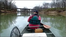  ?? NWA Democrat-Gazette/FLIP PUTTHOFF ?? Bland works a crank bait near the Arkansas 45 bridge. The White River where it joins Beaver Lake can be good for catching walleye and white bass during spring.