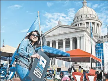  ?? SUE OGROCKI/AP ?? Teachers continue their protest over school funding and higher pay Tuesday at the state Capitol in Oklahoma City.