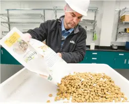  ?? RICK KINTZEL/THE MORNING CALL ?? Michael Hieger, senior vice president of manufactur­ing at Freshpet, pours out product for a quality assurance inspection at the company’s Kitchen 2.0 site in Hanover Township, Northampto­n County, in this 2020 file photo.