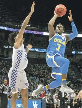  ?? Scott Threlkeld Associated Press ?? AARON HOLIDAY SHOOTS over Kentucky’s Shai Gilgeous-Alexander in New Orleans. UCLA coach Steve Alford doesn’t like to take Holiday out of close games.