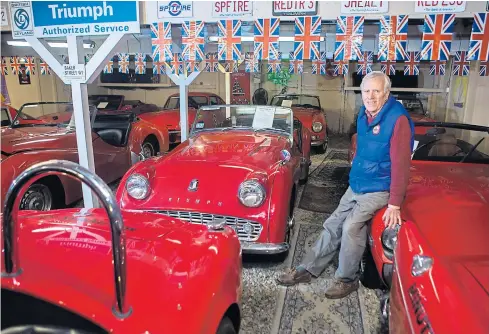  ??  ?? Bill Putman with a small number of his collection of 45 classic mostly-British cars.