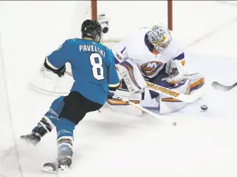  ?? Eric Risberg / Associated Press ?? Sharks center Joe Pavelski fires a shot at former San Jose goalie Thomas Greiss, who stopped 40 shots in the Islanders’ victory at SAP Center.