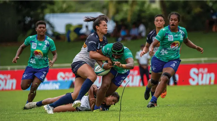  ?? Photo: Leon Lord ?? Strong running Rooster Chicken Fijiana Drua second five eight Merewai Cumu takes on the Brumbies players with first five eight Ani Mei (left) and flanker Sulita Waisega in support during their Super W opener at Prince Charles Park in Nadi on March 25, 2023.