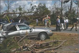  ?? The Associated Press ?? PRESIDENTI­AL TOUR: President Donald Trump and first lady Melania Trump tour a neighborho­od affected by Hurricane Michael, Monday, in Lynn Haven, Fla.