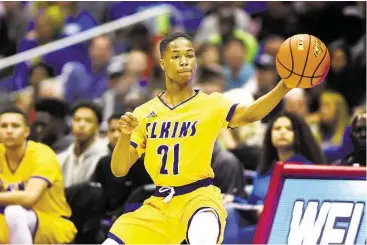  ?? Jerry Baker photos / For the Chronicle ?? Elkins senior guard Tyrik Armstrong makes a pass against Lancaster in the UIL Class 5A boys basketball state championsh­ip game at the Alamodome in San Antonio last weekend.
