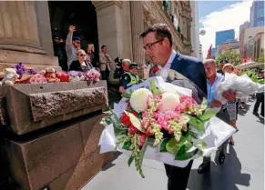  ?? PHOTO: GETTY IMAGES ?? Victorian Premier Daniel Andrews lays flowers at Bourke Street Mall yesterday to honour the victims of the attack.