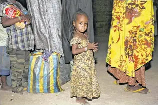  ??  ?? ASSOCIATED PRESS A girl rescued by Nigerian soldiers from Boko Haram extremists lines up with others for food upon their arrival at a refugee camp in Yola, Nigeria, on Saturday, They were among a group of 275 people.