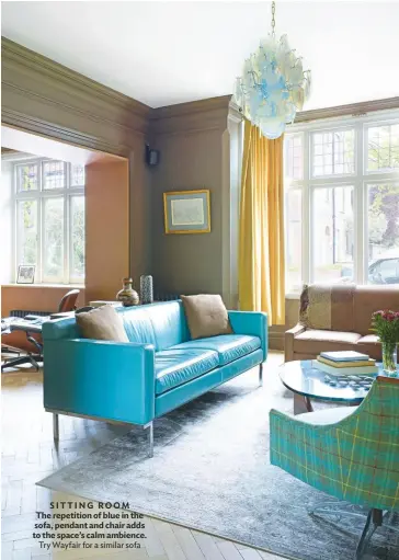  ??  ?? SITTING ROOM The repetition of blue in the sofa, pendant and chair adds to the space’s calm ambience. Try Wayfair for a similar sofa