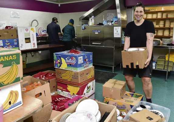  ?? PHOTO: GREGOR RICHARDSON ?? Don’t waste a plate . . . Fi Clements (right) with some of the many dishes for the Moana Nui Festival as Jonny Visser (left) and Lyeta Payet work at the sink at Arai Te Uru Marae on Thursday.