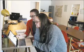  ?? File photo ?? A man and woman share a co-working space. Employment trends show a greater number of people are unable to find full-time employment and rely on freelance work to get by, according to the Middlesex County United Way.