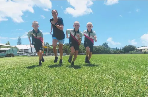  ??  ?? FASTER LEARNERS: Former Olympian and Commonweal­th games’ medallist Jill Boltz goes for a run with Holy Cross School Year 5 students Sam Turner and Katelyn and Siannah McGee.