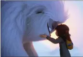  ?? DREAMWORKS ANIMATION LLC. VIA AP ?? Yi (voiced by Chloe Bennet) embraces the lost yeti she found living on the roof of her Shanghai apartment building. The weekend’s number one release deals with her efforts to get the creature back to its home.