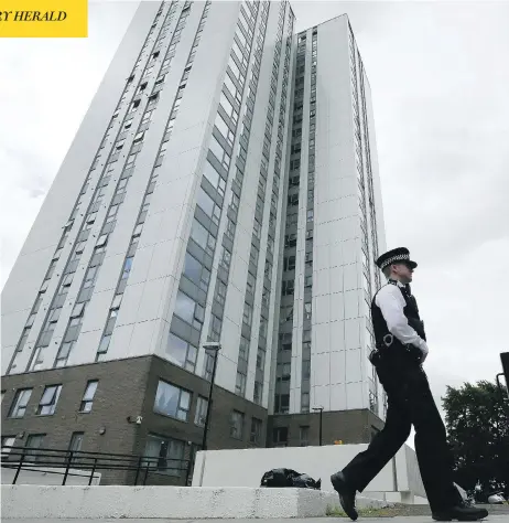  ?? TIM IRELAND / THE ASSOCIATED PRESS ?? A police officer patrols outside an apartment tower in London that was evacuated after fire inspectors concluded the building was unsafe.
