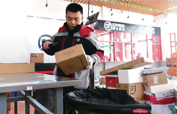  ?? ?? An express delivery company employee sorts parcels at a dispatchin­g station in Hefei, capital of Anhui Province. Couriers have been required to give doorstep deliveries unless a recipient gives explicit permission to use lockers since March 1 when a new regulation kicked in. — IC