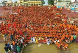  ?? — PTI ?? Kanwariyas perform rituals at the Narmada river as they commence their ‘ yatra’ during the holy month of Sawan in Bhopal on Saturday.