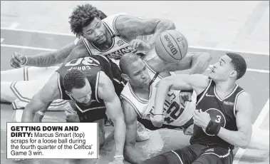  ?? AP ?? GETTING DOWN AND DIRTY: Marcus Smart (top) scraps for a loose ball during the fourth quarter of the Celtics’ Game 3 win.