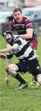  ??  ?? Crescent loose forward Andrew Carruthers is tackled by Clutha Valley’s Crewze Kingi during a Southern regional club semifinal in Kaitangata on Saturday. Crescent won 2422.