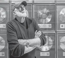  ?? ARLEN REDEKOP ?? Bruce Allen poses in front of a wall of gold records at his office in Vancouver May 12.