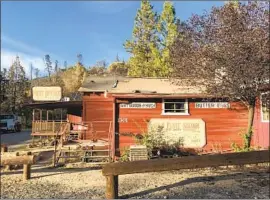  ?? Faith E. Pinho Los Angeles Times ?? THE GOLD FLAKE SALOON survived the North Complex f ire and sits relatively untouched in the f ire- scorched town of Feather Falls, Calif., on Thursday.