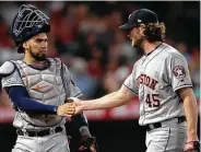  ?? Kyusung Gong / Associated Press ?? Catcher Robinson Chirinos, left, hands it to Gerrit Cole during a smooth outing for the Astros starter.