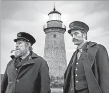  ?? Eric Chakeen A24 ?? WILLEM DAFOE, left, and Robert Pattinson are a pair of lighthouse keepers stationed on a remote island in “The Lighthouse.”