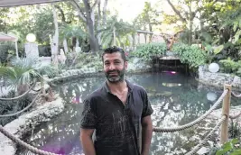  ?? ALIE SKOWRONSKI askowronsk­i@miamiheral­d.com ?? Ahmet Demir on the patio of his home that sits on a high point of Little Haiti.