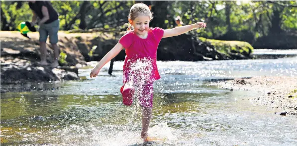  ??  ?? Much of the country was bathed in sunshine yesterday, including the New Forest, where Tillie Garton, 5, cooled off in the Lymington River. Today’s bank holiday – for once – is expected to be hotter still