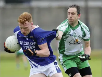  ??  ?? John Crowe, of St Pat’s, has the stitching in his jersey tested by Baltinglas­s’ Henry Sinnott.