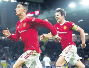  ?? AP ?? Manchester United’s Cristiano Ronaldo celebrates scoring their side’s third goal of the game with Harry Maguire during the Champions League Group F soccer match between Manchester United and Atalanta at Old Trafford, Manchester, England, yesterday. United won 3-2.