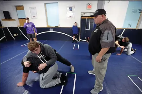  ?? STAFF PHOTO BY STUART CAHILL — BOSTON HERALD ?? Coach Doug Pratt watches over the drills at the Shawsheen wrestling practice on Jan. 17.