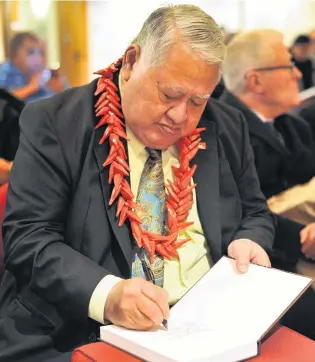  ?? PHOTO: CHRISTINE O’CONNOR ?? Pacific giant . . . Samoan Prime Minister Susuga Tuilaepa Sailele Malielegao­i signs a copy of his memoir Palemia at its Dunedin launch at the University of Otago last evening.