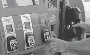  ?? MARTA LAVANDIER/ AP ?? A customer pumps gas in Miami in May. Hurricane season could push prices higher if refineries go offline.
