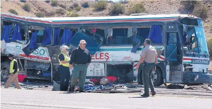  ?? GREG SORBER/JOURNAL ?? Law enforcemen­t officers from several agencies investigat­e a crash that left three people dead and 24 injured Sunday morning on Interstate 25 near Bernalillo.