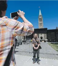  ?? SEAN KILPATRICK / THE CANADIAN PRESS ?? With preparatio­ns for Canada Day underway, tourists like these who visited Ottawa recently are being assured by police that there are “lots of eyes and ears out there” to keep Parliament Hill safe during the celebratio­n.