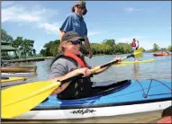  ?? NEWS-SENTINEL FILE PHOTOGRAPH ?? Left: Dan Arbuckle, owner of Headwaters Kayak Shop, helps Mac Bourland, of Modesto, get into a kayak during the Lodi Lake Paddle Festival at the lake on April 16, 2016.