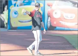  ?? PHOTOS BY BRANDON VALLANCE — SANTA CRUZ SENTINEL ?? Arizona Diamondbac­ks rookie pitcher Tyler Gilbert points to familiar faces in the stands during batting practice at Oracle Park in San Francisco on Tuesday. He’ll make his first MLB start Saturday night against San Diego in Phoenix.