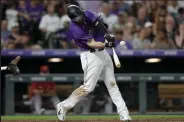  ?? ?? C.J. Cron (25) of the Colorado Rockies hits a RBI songle against the Arizona Diamondbac­ks in the sixth inning at Coors Field on July 2.