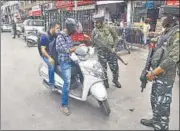  ?? ANI ?? Security personnel check the ID of a motorist on the eve of the second anniversar­y of nullificat­ion of Article 370, in Srinagar.