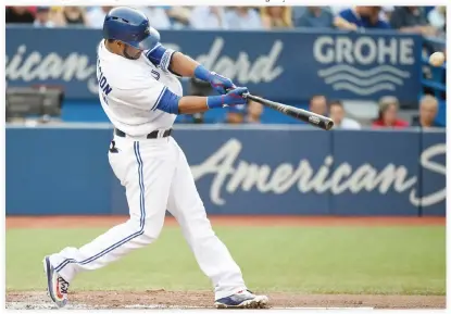  ??  ?? OPENING SALVO: Toronto Blue Jays’ Edwin Encarnacio­n hits a solo home run against the Baltimore Orioles during the first inning of a baseball game on Friday in Toronto. (AP)