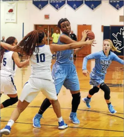  ?? GREGG SLABODA — TRENTONIAN PHOTO ?? Notre Dame’s Erika Porter, right, looks to pass the ball during a game against Ewing last season.