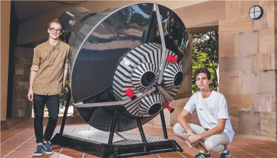  ?? Picture: Jerad Williams ?? Bond University students George Cary and Haydn Shaw stand next to a 700kg replica space capsule ahead of a forum on space and startups.