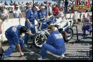  ??  ?? An agonisingl­y slow stop for Aaron Slight to change a punctured front tyre. Team mate Robert Holden stands by the rear jack. The team put up a remarkable performanc­e to finish 3rd outright and 1st 750.