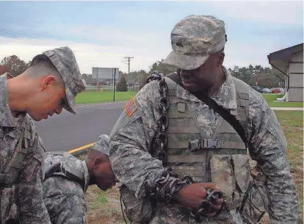  ?? PROVIDED BY BRUCE WEAVER ?? Maryland National Guard Sgt. Bruce Weaver wearing a chain as discipline.