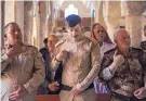  ??  ?? Soldiers sign a cross on their chest during Easter Mass at the Mar Yohanna Church (also known as the Saint John Church) in Qaraqosh, Iraq, on April 16, 2017.