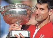  ??  ?? In this June 5, 2016, file photo, Serbia’s Novak Djokovic holds the trophy after defeating Britain’s Andy Murray in four sets 3-6, 6-1, 6-2, 6-4, in the finals of the French Open tennis tournament the Roland Garros stadium in Paris, France.